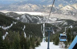 blue gondolas over a snowy ski run