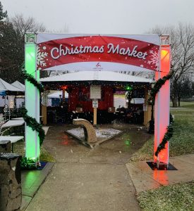 a green and red Christmas Market banner greets guests in Hayden, Idaho