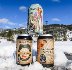 three Radio Beer cans stacked in snow
