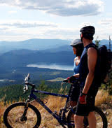 two bikers overlook a ride over the landscape