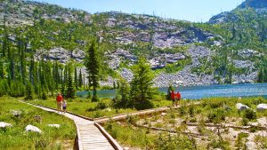 people walk outdoors on wooden paths in northern Idaho