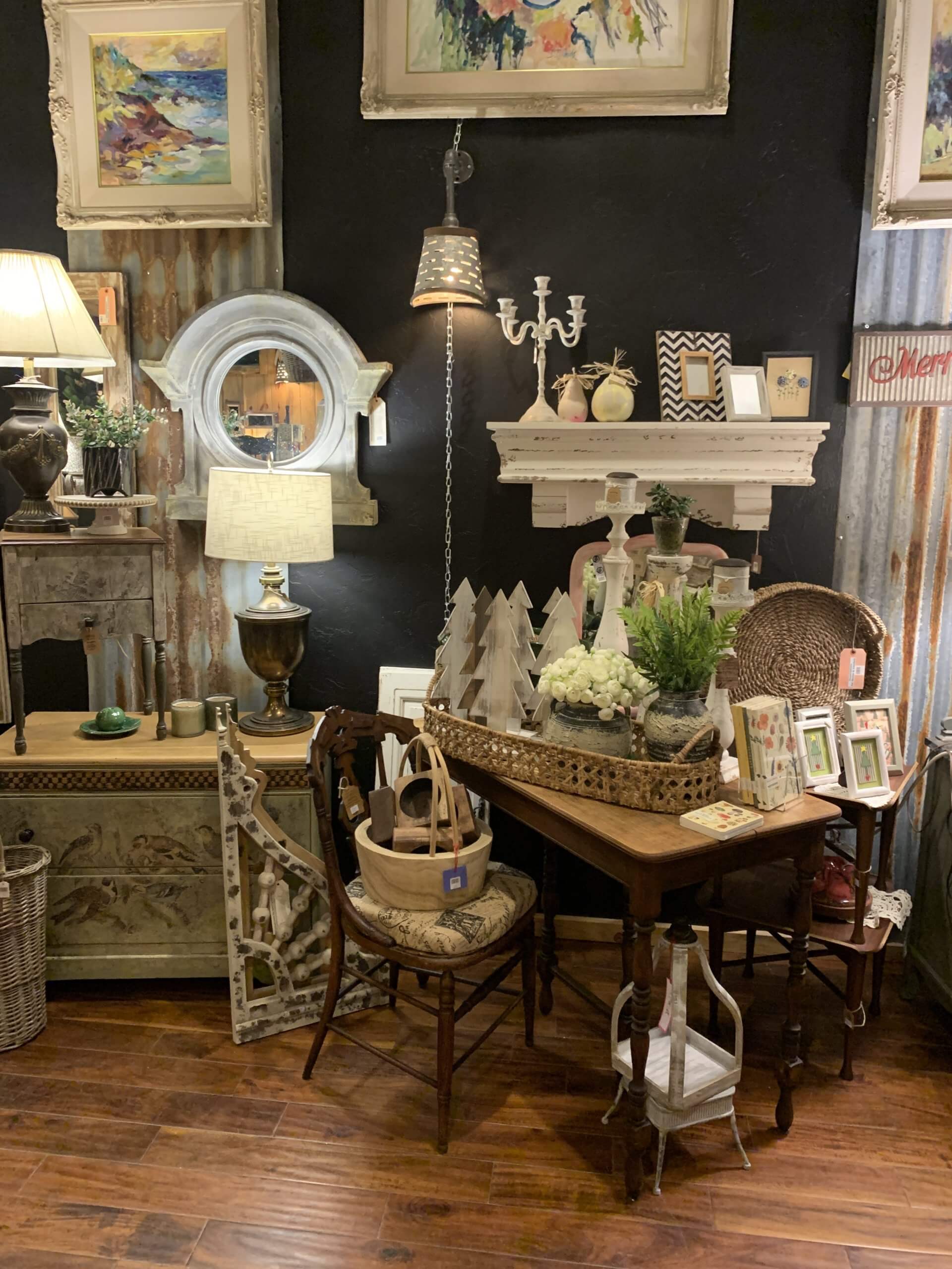 Various pieces of home decor, paintings, vintage chairs and other pieces of furniture on display at The Nest store.