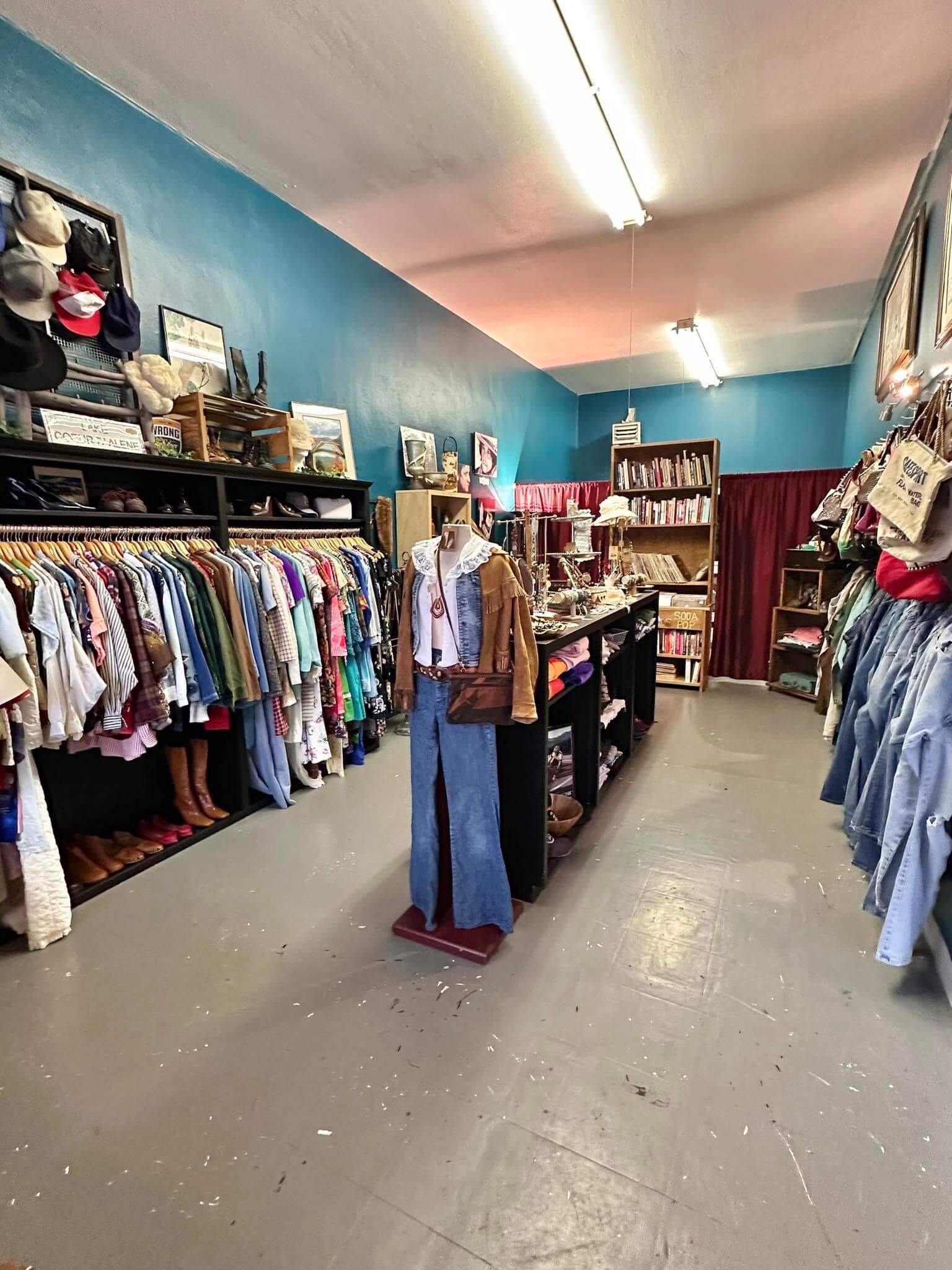 Several items of clothing hanging up on racks and displayed on shelves inside the Hidden Gems Shoppe.