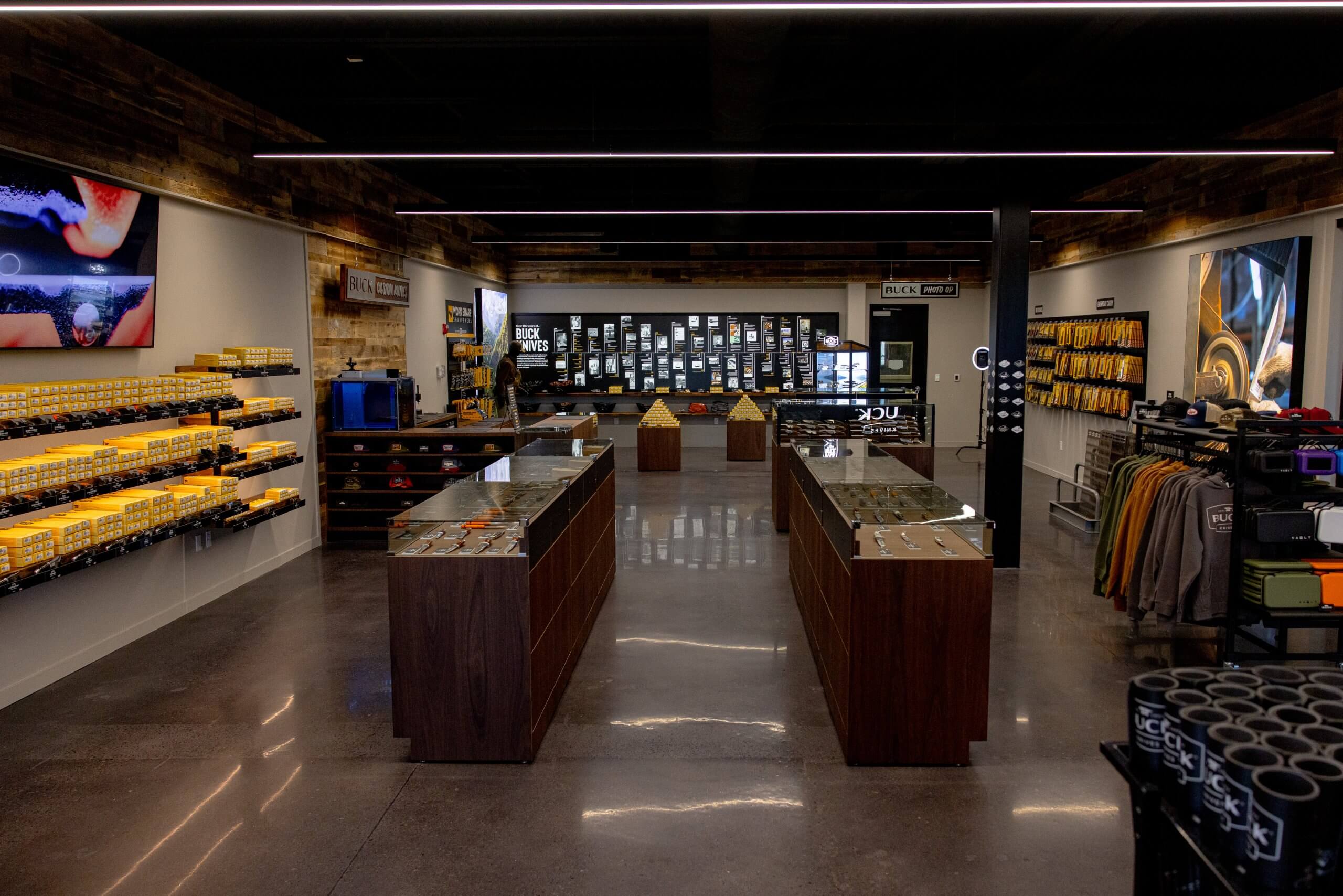 An interior view of items in display cases, clothing, cups and other goods for sale inside the Buck Knives shop.