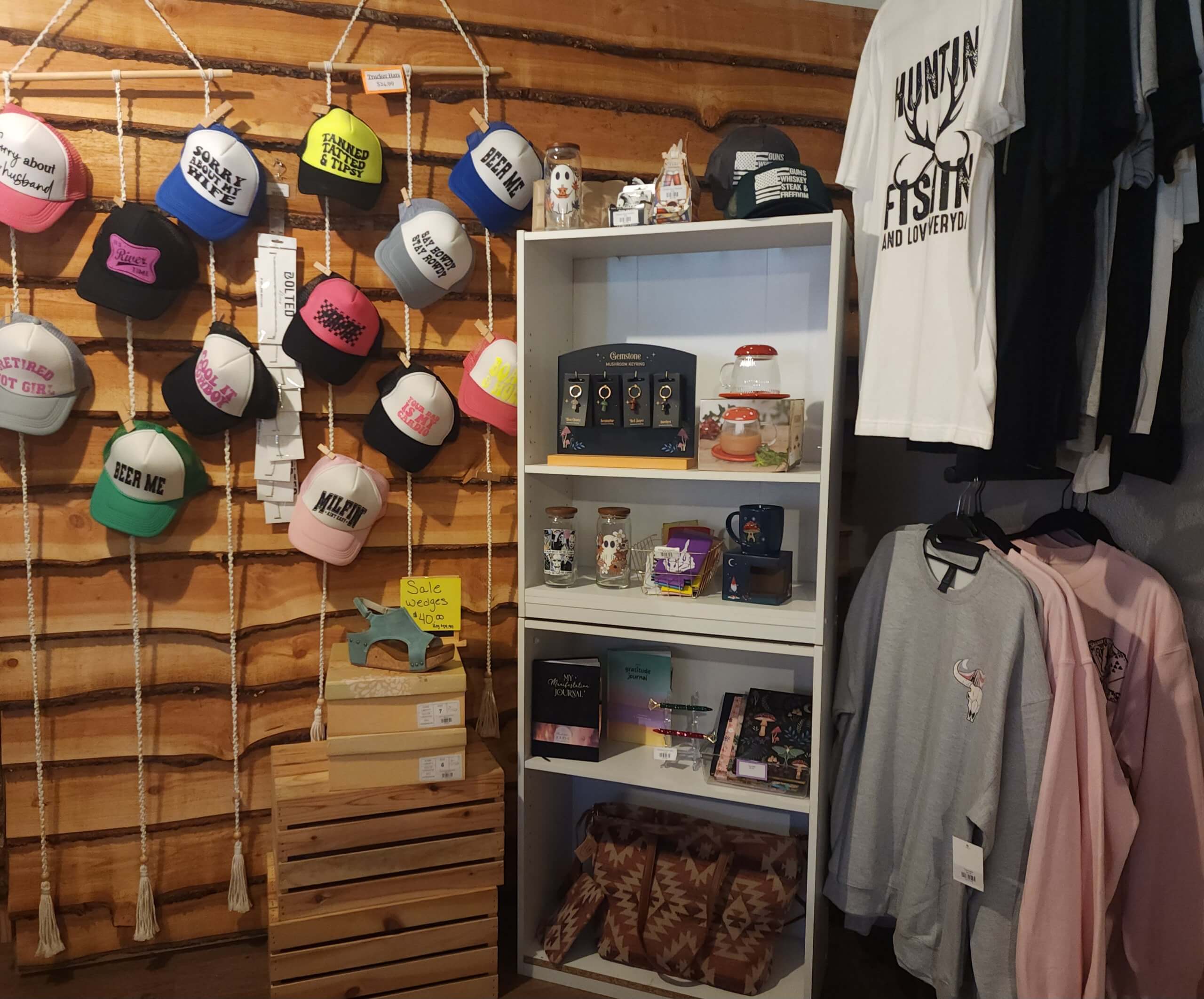 An interior view of the Mountain Top Boutique, with several hats, shirts, keychains and other paraphernalia displayed on racks and shelves.