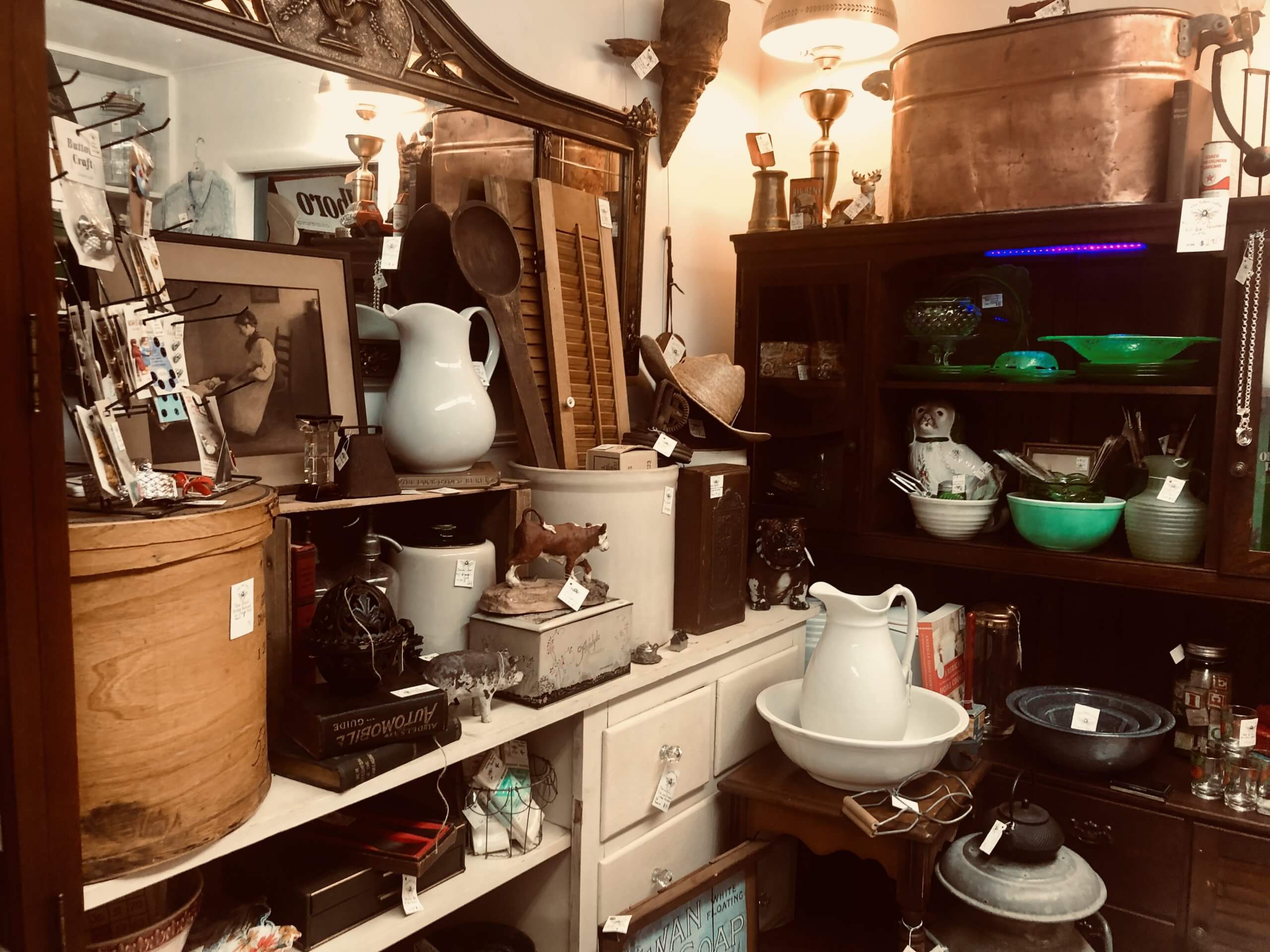 Several bowls, pitchers, lamps and other antiques displayed for sale at the Rusty Trunk.