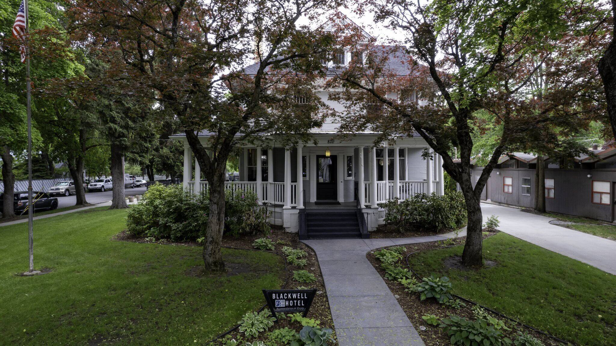 Exterior view of the Blackwell Hotel, surrounded by lush green trees and landscaped gardens.