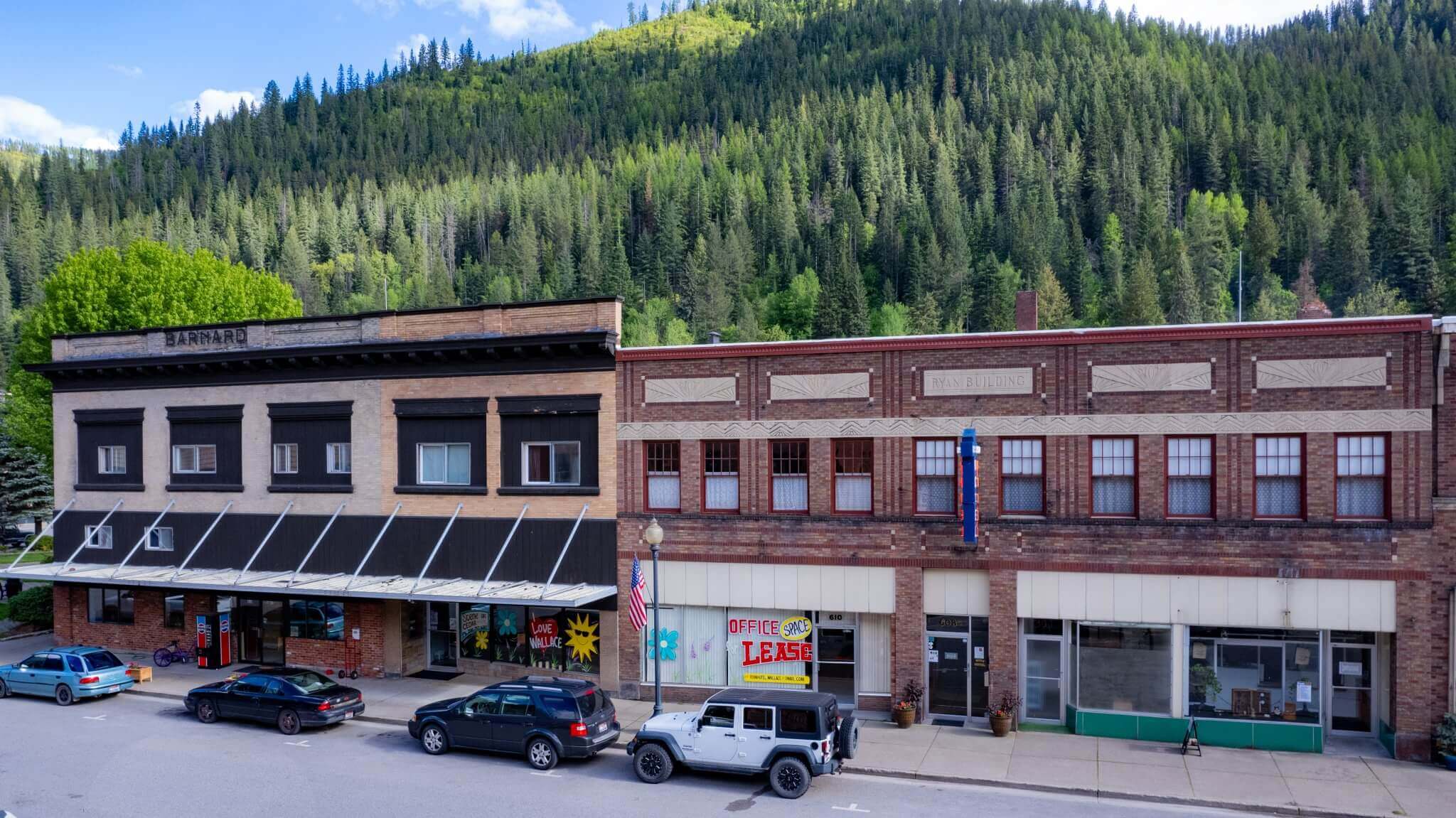 Ryan Hotel and nearby buildings with forested hills in the background.